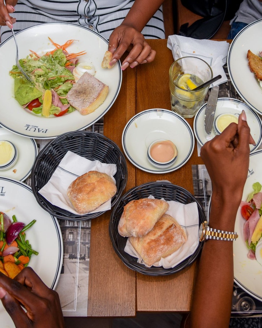 A full table at PAUL, plates passing between hands
